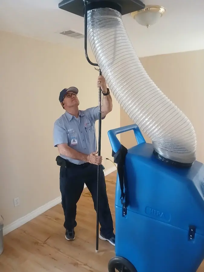 Furnace Tune-Up technician using HEPA equipment in Solon